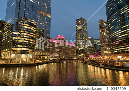 Night cityscape of Chicago skyscraper building. Chicago architecture of skyscraper. City night illuminated building. Skyscraper cityscape. Night city of Chicago. Business city Night cityscape of Chicago skyscraper building. Chicago architecture of skyscraper. City night illuminated building. Skyscraper cityscape. Night city of Chicago. Business city 140348809