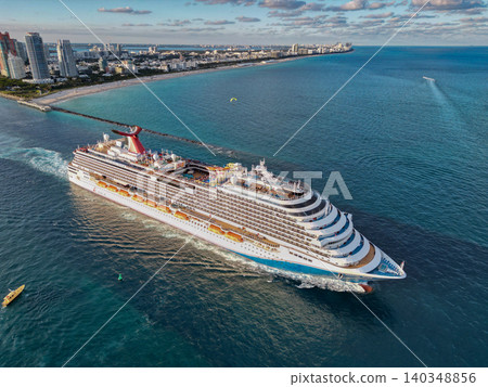 Miami, Florida, USA - November 24, 2024: Carnival Cruise line. Carnival magic. Cruise ship voyage. Aerial view of cruise ship tour and travel at sea. Ship leaving Miami beach port. Miami tour Miami, Florida, USA - November 24, 2024: Carnival Cruise line. Carnival magic. Cruise ship voyage. Aerial view of cruise ship tour and travel at sea. Ship leaving Miami beach port. Miami tour 140348856