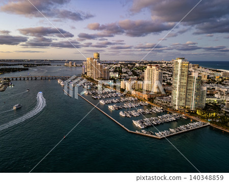 Private boat at sunrise. Marina with luxury sea boat. Yacht club and marina in Miami. Luxury marina with private yacht boat. Docked yacht boat in harbor. Marina dock. Luxury summer vacation in Miami 140348859