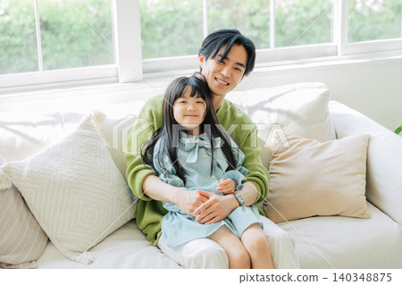 Parents relaxing on the sofa Parents relaxing on the sofa 140348875