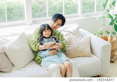 Parents relaxing on the sofa Parents relaxing on the sofa 140348877