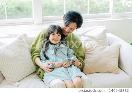Parents relaxing on the sofa Parents relaxing on the sofa 140348882