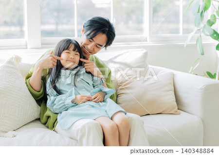 Parents relaxing on the sofa Parents relaxing on the sofa 140348884