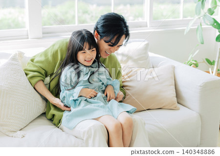 Parents relaxing on the sofa Parents relaxing on the sofa 140348886