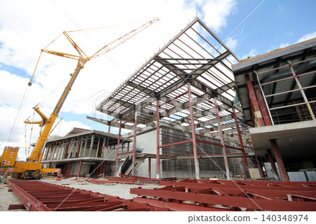 Steel frame of a new factory building under construction Steel frame of a new factory building under construction 140348974