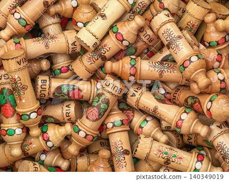 Wooden souvenirs with painted roses and Bulgaria lettering, craft market display. Souvenir pattern shows Balkan travel, folk art, rose culture, tourism, handmade gift. Bulgarian craft background Wooden souvenirs with painted roses and Bulgaria lettering, craft market display. Souvenir pattern shows Balkan travel, folk art, rose culture, tourism, handmade gift. Bulgarian craft background 140349019