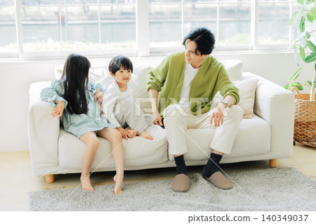 Parents relaxing on the sofa Parents relaxing on the sofa 140349037