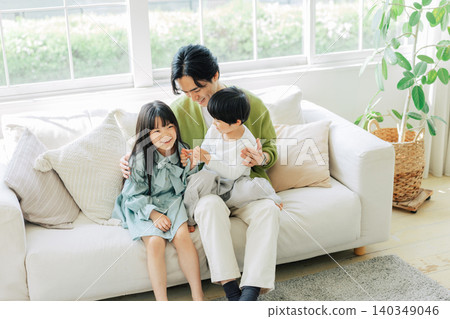 Parents relaxing on the sofa Parents relaxing on the sofa 140349046