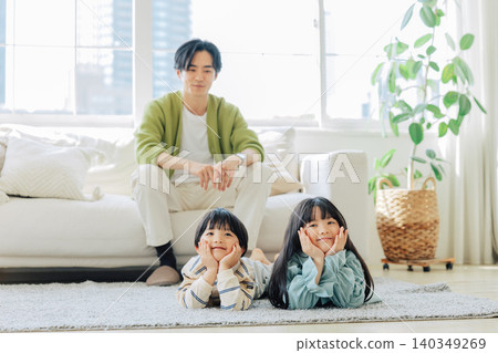 Parents and children relaxing in the living room Parents and children relaxing in the living room 140349269