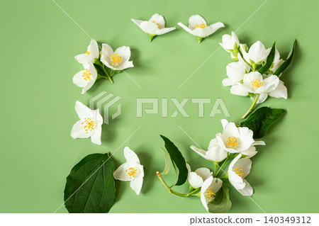 elegant white flowers arranged on green background elegant white flowers arranged on green background 140349312