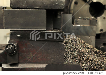 A lathe and metal chips in the workshop A lathe and metal chips in the workshop 140349375