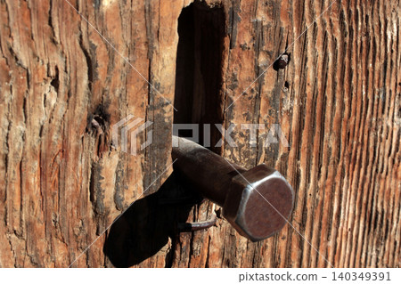 rusty nail lever to open and close old wooden door rusty nail lever to open and close old wooden door 140349391