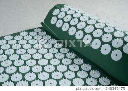 Green acupuncture applicator mat for body relaxation and alternative medicine Green acupuncture applicator mat for body relaxation and alternative medicine 140349475