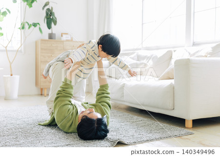 Father and son playing in the living room Father and son playing in the living room 140349496