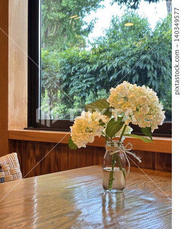 White hydrangeas displayed by the window White hydrangeas displayed by the window 140349577