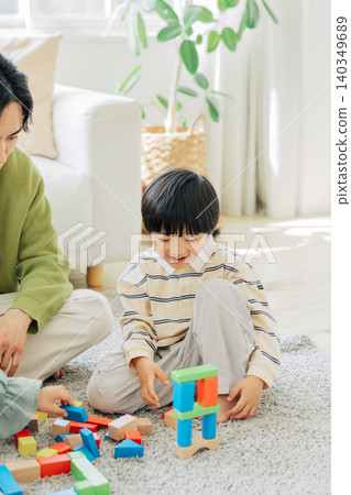 Boy playing with building blocks Boy playing with building blocks 140349689