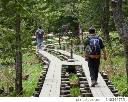Tourists hiking on the walking trails of Kamikochi, a popular spring tourist spot. Tourists hiking on the walking trails of Kamikochi, a popular spring tourist spot. 140349755