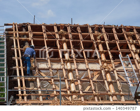A scene of construction work on the gassho-zukuri roofs of Shirakawa-go, a World Heritage site and popular tourist destination. A scene of construction work on the gassho-zukuri roofs of Shirakawa-go, a World Heritage site and popular tourist destination. 140349787