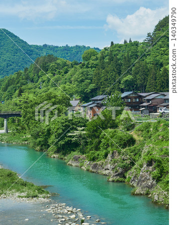 Early summer tourist attraction: Shirakawa-go, a World Heritage site, with its Gassho-zukuri village and the scenery of the Shogawa River. Early summer tourist attraction: Shirakawa-go, a World Heritage site, with its Gassho-zukuri village and the scenery of the Shogawa River. 140349790
