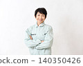A smiling Asian female worker with her arms crossed. 140350426