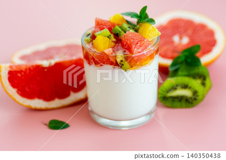 yogurt dessert with tropical fruits and citrus slices on minimal background yogurt dessert with tropical fruits and citrus slices on minimal background 140350438
