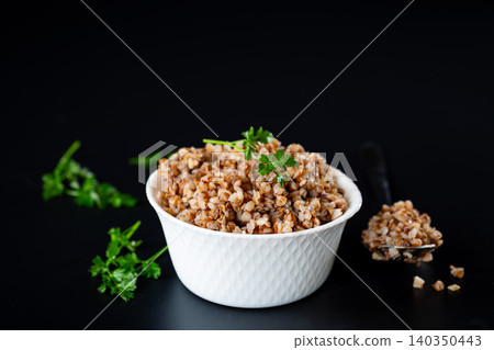 Healthy vegan buckwheat dish on dark kitchen background Healthy vegan buckwheat dish on dark kitchen background 140350443
