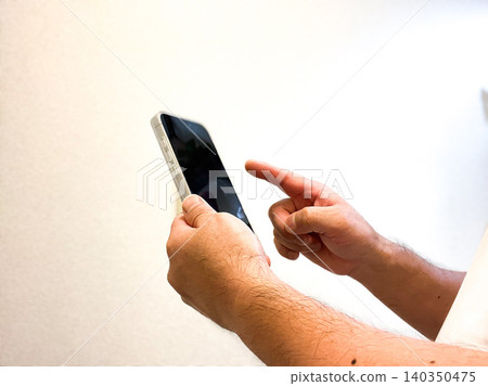 Hand holding a smartphone Hand holding a smartphone 140350475