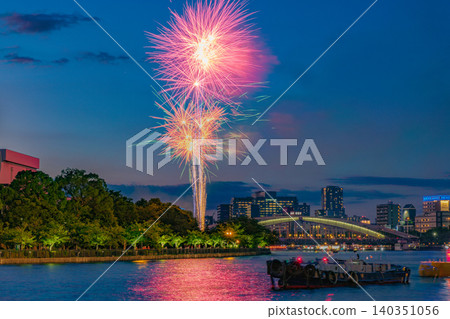 OSAKA - JULY 25, 2025: Spectacular colorful fireworks illuminating the night sky over the Okawa River during the historic Tenjin Matsuri festival OSAKA - JULY 25, 2025: Spectacular colorful fireworks illuminating the night sky over the Okawa River during the historic Tenjin Matsuri festival 140351056