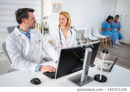 Doctors and nurses working together in hospital clinic office Doctors and nurses working together in hospital clinic office 140351200