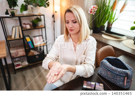Engaging in a beauty routine in a cozy indoor space with natural light 140351465