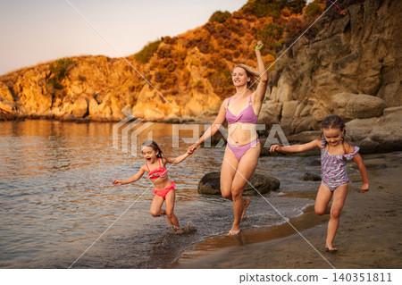 Mother and daughters enjoying summer beach vacation in Greece 140351811