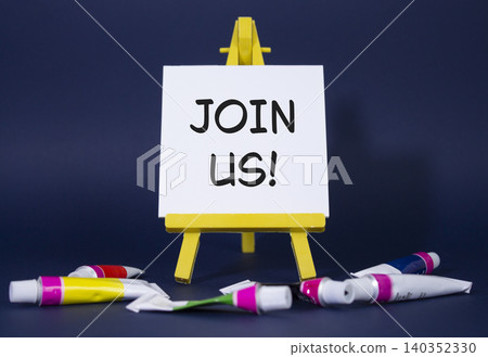 Join us symbol. Concept word Join us on wooden blocks. Beautiful deep blue background with paints and easel. Business and Join us concept. Copy space Join us symbol. Concept word Join us on wooden blocks. Beautiful deep blue background with paints and easel. Business and Join us concept. Copy space 140352330