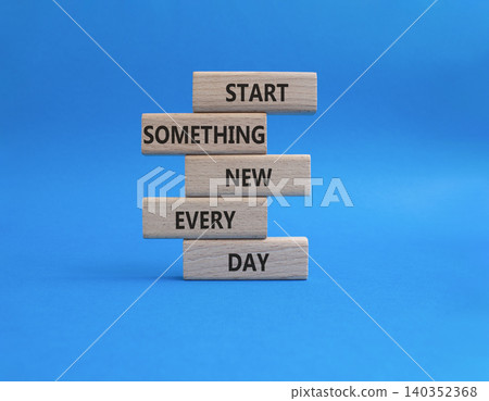 New symbol. Wooden blocks with words Start Something New Every Day. Beautiful blue background. Business and New concept. Copy space 140352368