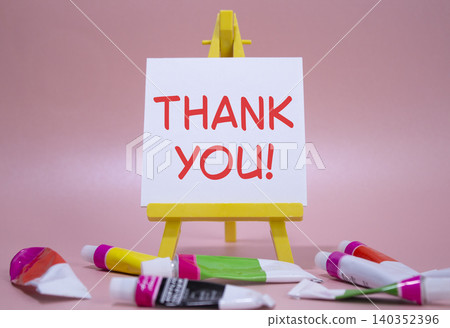 Thank you symbol. Wooden blocks with words Thank you. Beautiful pink background with paints and easel. Business and Thank you concept. Copy space. Thank you symbol. Wooden blocks with words Thank you. Beautiful pink background with paints and easel. Business and Thank you concept. Copy space. 140352396