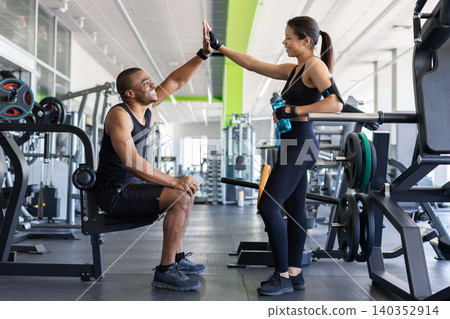 Young black exchanging high five in fitness center after successful workout Young black exchanging high five in fitness center after successful workout 140352914