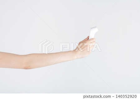 Hand holding infrared thermometer for temperature screening Hand holding infrared thermometer for temperature screening 140352920