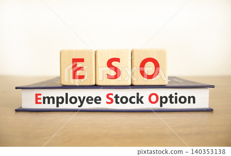 ESO employee stock option symbol. Concept words ESO employee stock option on beautiful wooden blocks and book. Beautiful white background. Business ESO employee stock option concept. Copy space. 140353138