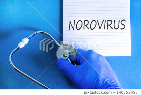Norovirus medical words symbol. Concept words Norovirus on beautiful white note. Beautiful blue background. Doctor hand in blue medical glove. Stethoscope. Medical Norovirus concept. Copy space. Norovirus medical words symbol. Concept words Norovirus on beautiful white note. Beautiful blue background. Doctor hand in blue medical glove. Stethoscope. Medical Norovirus concept. Copy space. 140353453
