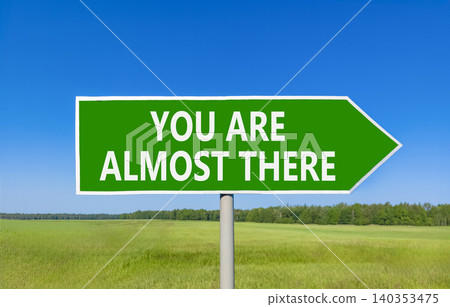 You are almost there symbol. Concept words You are almost there on beautiful green road sign. Beautiful blue sky background. Business You are almost there motivational support concept. Copy space You are almost there symbol. Concept words You are almost there on beautiful green road sign. Beautiful blue sky background. Business You are almost there motivational support concept. Copy space 140353475