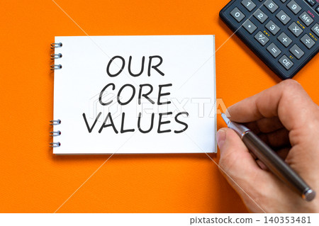 Our core values words symbol. Concept words Our core values on beautiful white note. Beautiful orange background. Businessman hand. Business our core values motivational support concept. Copy space. Our core values words symbol. Concept words Our core values on beautiful white note. Beautiful orange background. Businessman hand. Business our core values motivational support concept. Copy space. 140353481