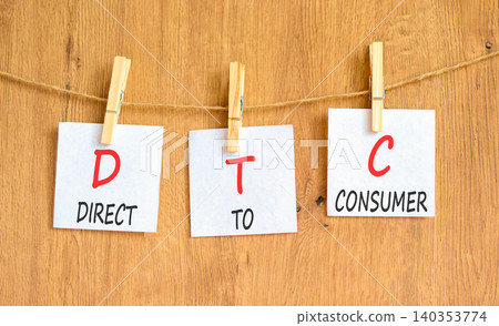 DTC direct to consumer symbol. Concept words DTC direct to consumer on beautiful white papers on wooden clothespins. Beautiful wooden background. Business DTC direct to consumer concept. Copy space. DTC direct to consumer symbol. Concept words DTC direct to consumer on beautiful white papers on wooden clothespins. Beautiful wooden background. Business DTC direct to consumer concept. Copy space. 140353774