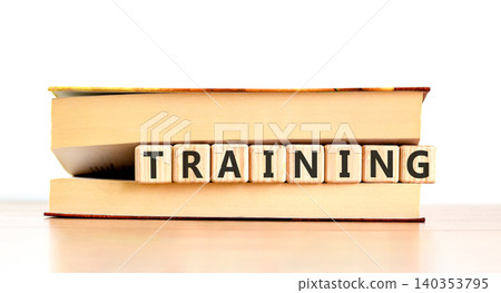 Training word symbol. Concept word Training on beautiful wooden blocks in beautiful book. Beautiful wooden table white background. Business support help training word concept. Copy space. Training word symbol. Concept word Training on beautiful wooden blocks in beautiful book. Beautiful wooden table white background. Business support help training word concept. Copy space. 140353795