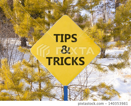 Tips and tricks words symbol. Concept words Tips and tricks on beautiful yellow road sign. Beautiful winter forest background. Business tips and tricks motivational support concept. Copy space. Tips and tricks words symbol. Concept words Tips and tricks on beautiful yellow road sign. Beautiful winter forest background. Business tips and tricks motivational support concept. Copy space. 140353981