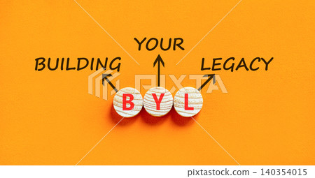 BYL building your legacy symbol. Concept words BYL building your legacy on beautiful wooden circles. Beautiful orange background. Business BYL building your legacy concept. Copy space. BYL building your legacy symbol. Concept words BYL building your legacy on beautiful wooden circles. Beautiful orange background. Business BYL building your legacy concept. Copy space. 140354015