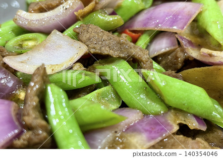 Delicious beef and green vegetable stir fry highlighting tender meat textures and vibrant ingredients in a satisfying meal 140354046