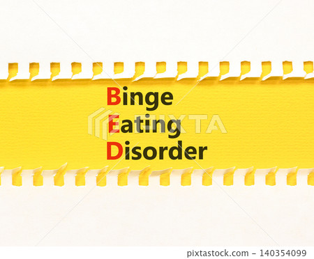 BED binge eating disorder symbol. Concept words BED binge eating disorder on beautiful yellow paper. Beautiful white background. Medical BED binge eating disorder concept. Copy space. BED binge eating disorder symbol. Concept words BED binge eating disorder on beautiful yellow paper. Beautiful white background. Medical BED binge eating disorder concept. Copy space. 140354099