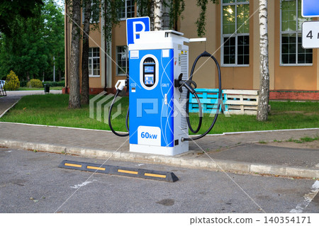 EV charging station interface screen with cable plug, green energy public electric vehicle power supply unit 140354171