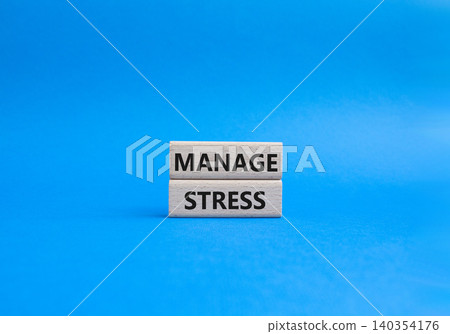 Manage stress symbol. Concept word Manage stress on wooden blocks. Beautiful blue background. Business and Manage stress concept. Copy space 140354176