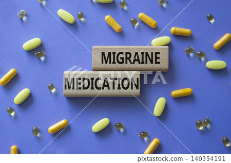 Migraine medication symbol. Concept word Migraine medication on wooden blocks. Beautiful purple background with pills. Medicine and Migraine medication. Copy space Migraine medication symbol. Concept word Migraine medication on wooden blocks. Beautiful purple background with pills. Medicine and Migraine medication. Copy space 140354191