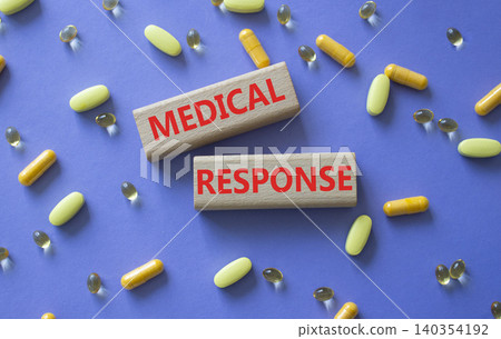 Medical response symbol. Concept word Medical response on wooden blocks. Beautiful purple background with pills. Medicine and Medical response. Copy space Medical response symbol. Concept word Medical response on wooden blocks. Beautiful purple background with pills. Medicine and Medical response. Copy space 140354192